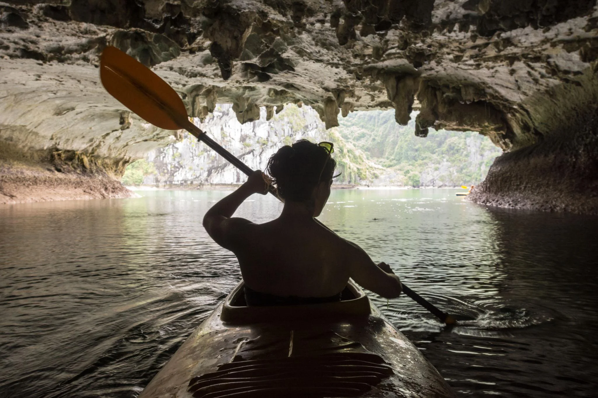 Ha Long Bay kayaking through limestone cave Vietnam overnight cruise